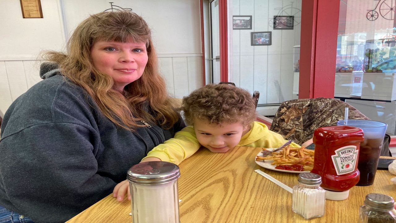 Heather Bable and her son Ashton poses for a photograph, Feb. 25, 2023 at Sprinklz On Top restaurant in East Palestine, Ohio. Bable and her children live less than a half-mile from where a train derailed in a fiery crash Feb. 3, forcing them to evacuate and raising fears about contamination of air, soil and water.  (AP Photo/John Flesher)