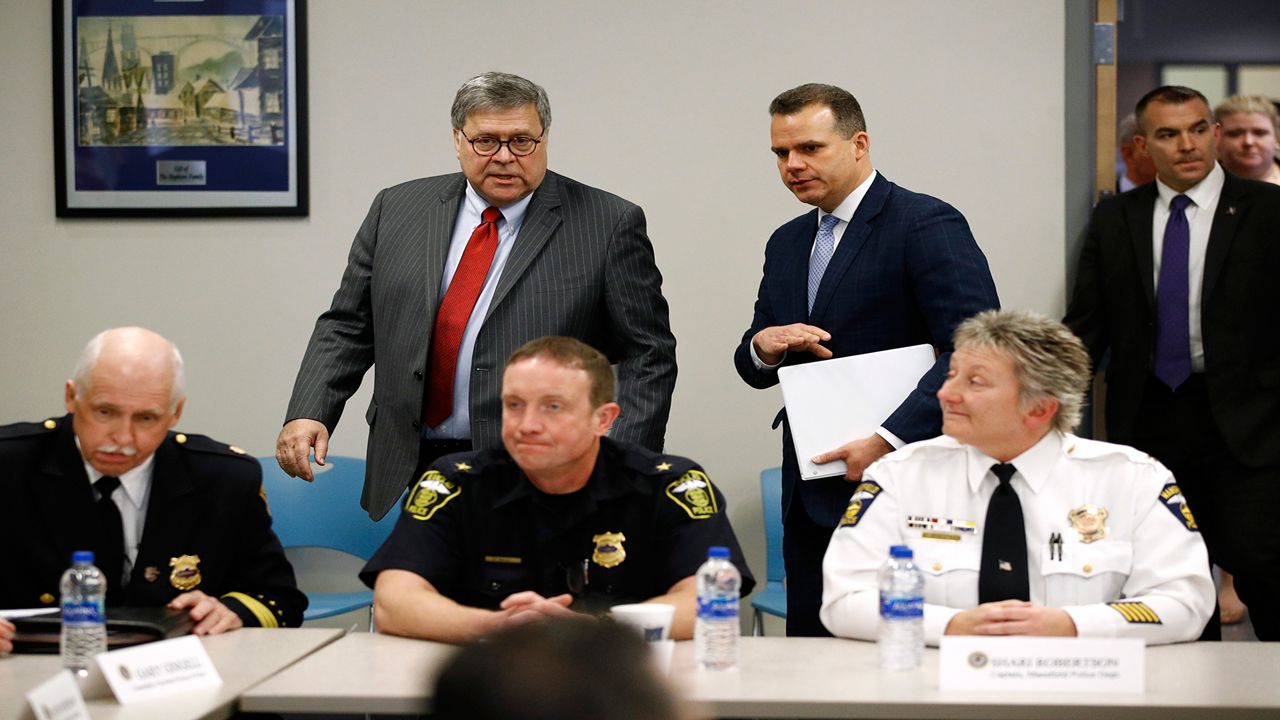 Attorney General William Barr, center, arrives at a roundtable with members of local, state and federal law enforcement agencies at the Cleveland Police Department's Third District station, Thursday, Nov. 21, 2019, in Cleveland. Following Barr is Justin Herdman, U.S. Attorney for the Northern District of Ohio. (AP Photo/Patrick Semansky)