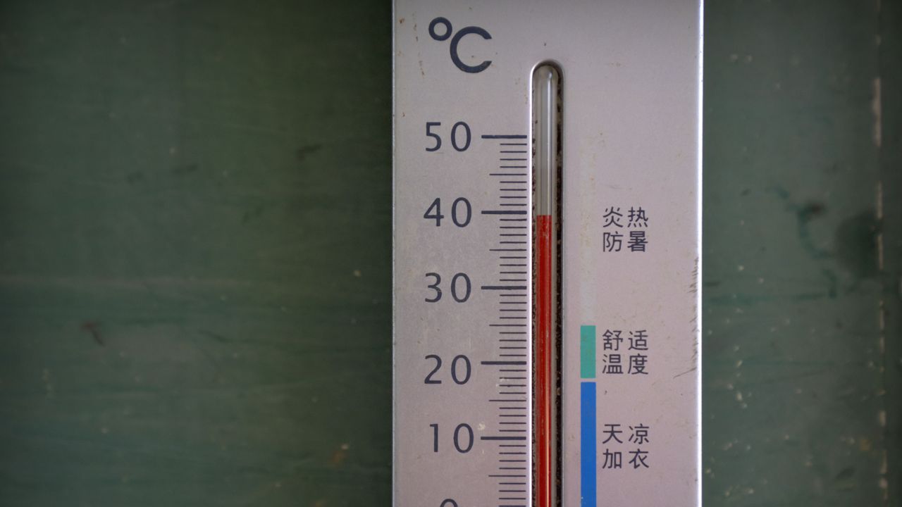 A thermometer shows a temperature of nearly 40 degrees Celsius (104 F) in the shade before midday in Longquan village in southwestern China's Chongqing Municipality, Saturday, Aug. 20, 2022. (AP Photo/Mark Schiefelbein)