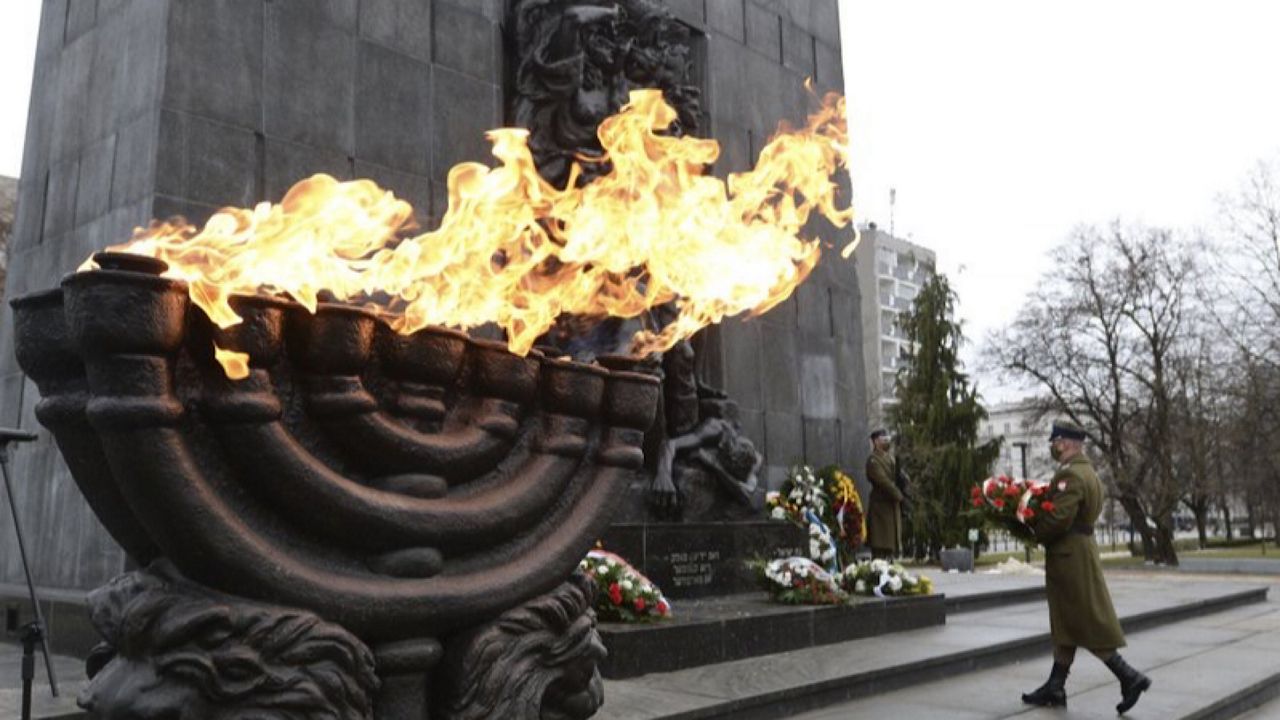 A wreath is laid at the monument to the Heroes of the Warsaw Ghetto in Warsaw, Poland, on Wednesday, Jan. 27, 2021, as part of world observances of the 76th anniversary of the liberation of the Nazi German death camp Auschwitz. Some 1.1 million people, mostly Jewish, were killed during World War II. Most observances were held online, due to the coronavirus pandemic, and only few people attended the ceremony at the monument.(AP Photo/Czarek Sokolowski)
