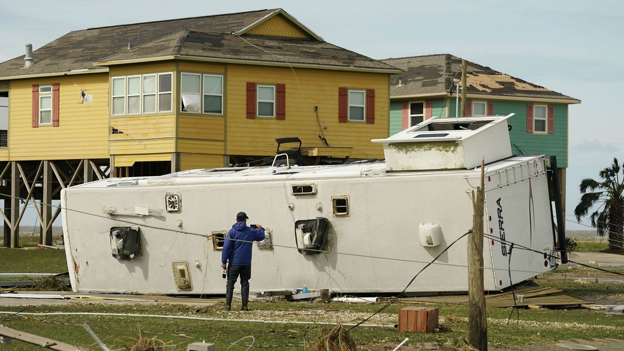 A journalist photographs damage left in the wake of Hurricane Laura, Thursday, Aug. 27, 2020, in Holly Beach, La. (AP Photo/Eric Gay)