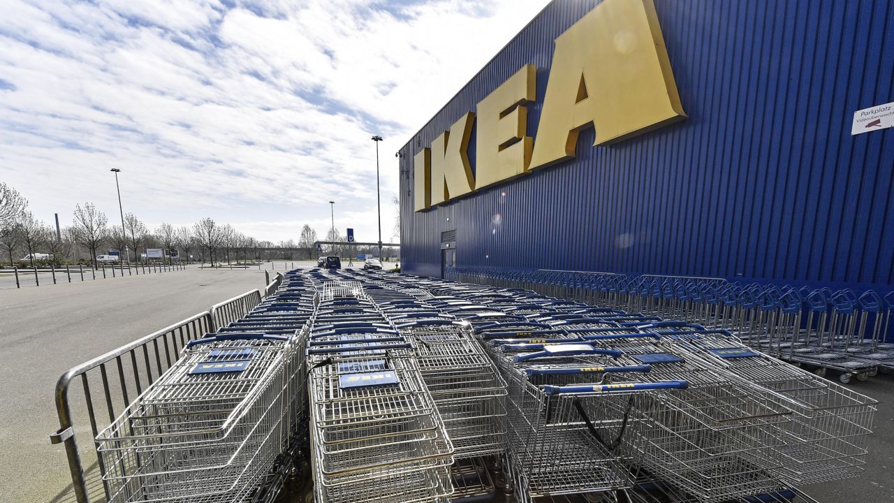 Empty trolleys are stored in front of a closed IKEA store in Duisburg, Germany, Germany, Thursday, March 19, 2020. (AP Photo/Martin Meissner)