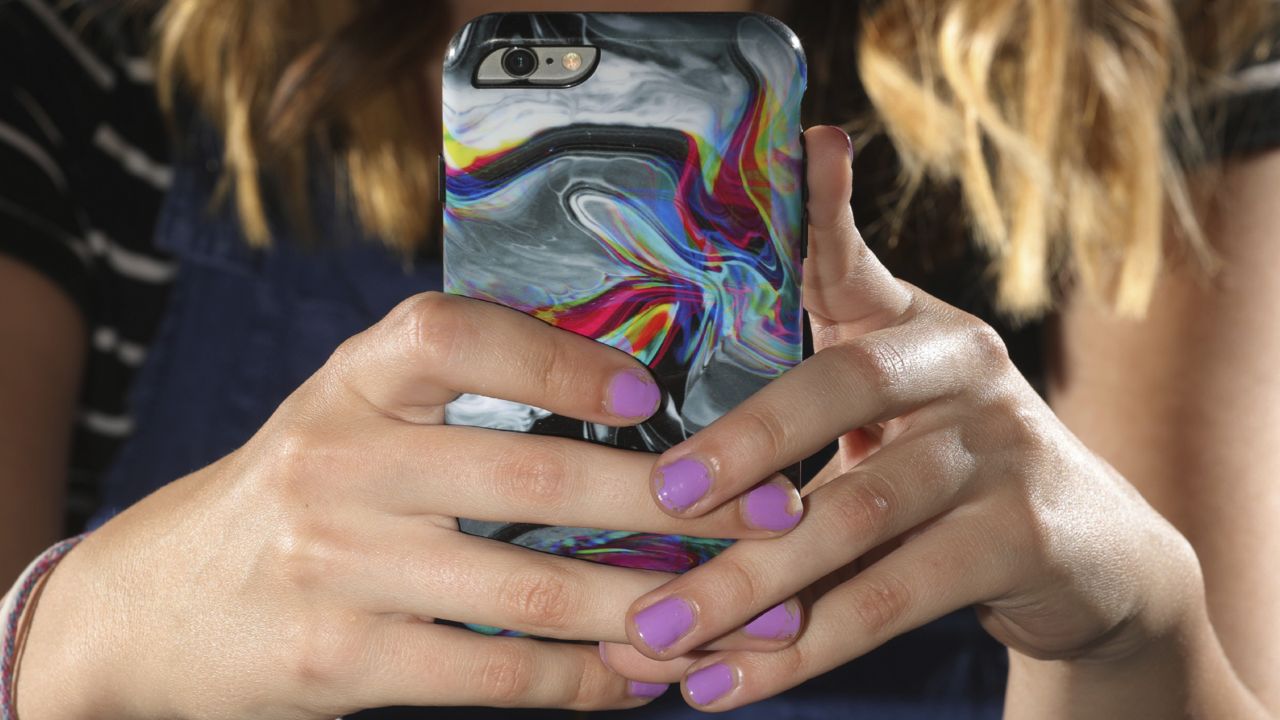 FILE: In this Monday, July 22, 2019, photo, a person looks at their phone at home in Draper, Utah. (AP Photo/Rick Bowmer)