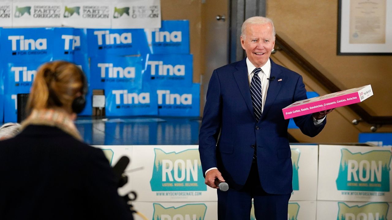 President Joe Biden holds a box of doughnuts during a grassroots volunteer event with the Oregon Democrats at the SEIU Local 49 in Portland, Ore. on Friday, Oct. 14, 2022. (AP Photo/Carolyn Kaster)