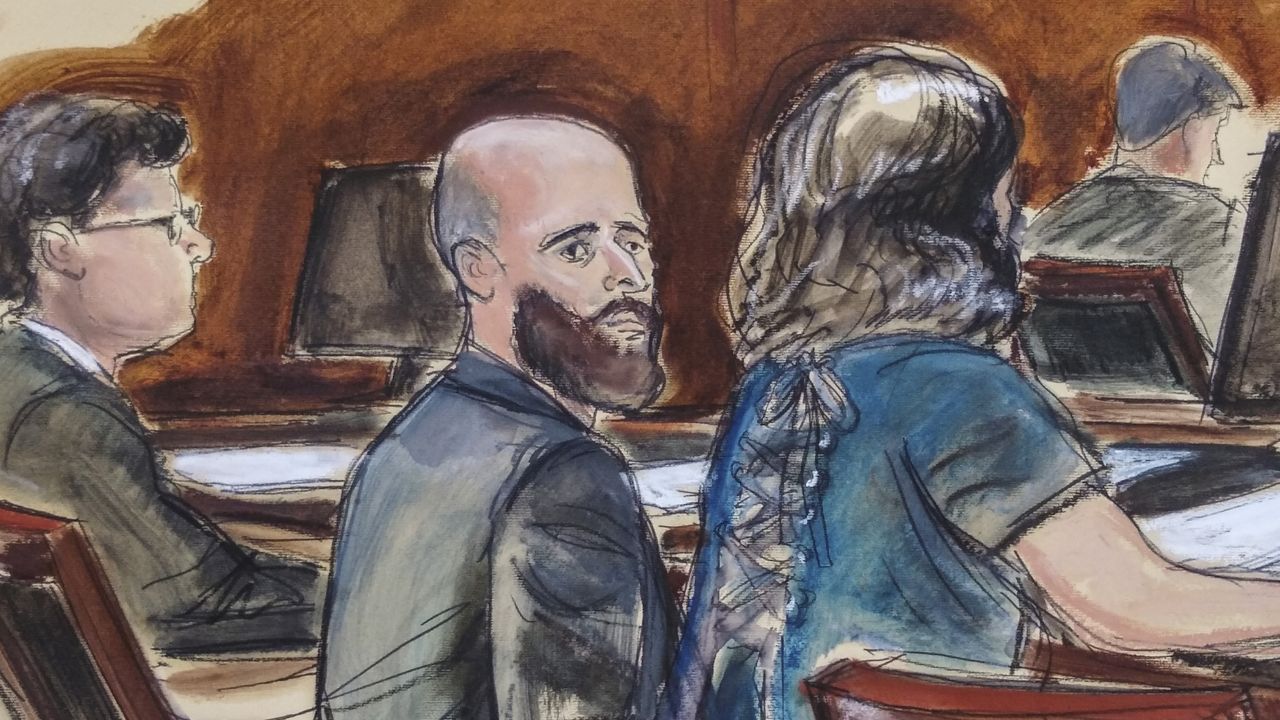 In this courtroom sketch, Joshua Schulte, center, is seated at the defense table flanked by his attorneys during jury deliberations, Wednesday March 4, 2020, in New York. (Elizabeth Williams via AP)