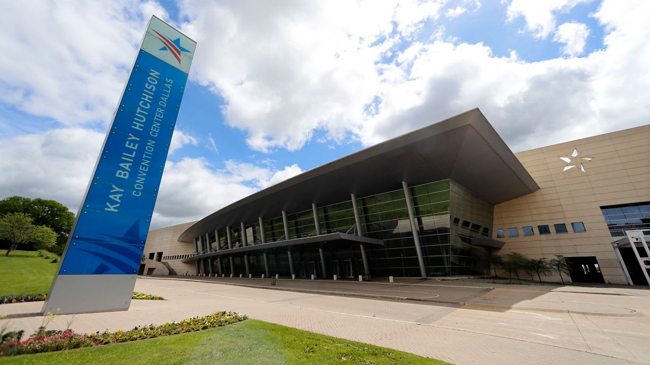 FILE - In this March 31, 2020, file photo, a sign sits in front of the Kay Bailey Hutchison Convention Center in downtown Dallas. (AP Photo/Tony Gutierrez File)