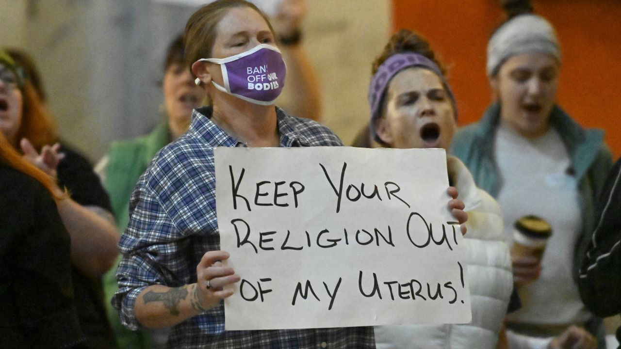 Protester outside the Kentucky Supreme Court chambers rally in favor of abortion rights as the Kentucky Supreme Court hears arguments whether to temporarily pause the state's abortion ban in Frankfort, Ky., Tuesday, Nov. 15, 2022. (AP Photo/Timothy D. Easley)