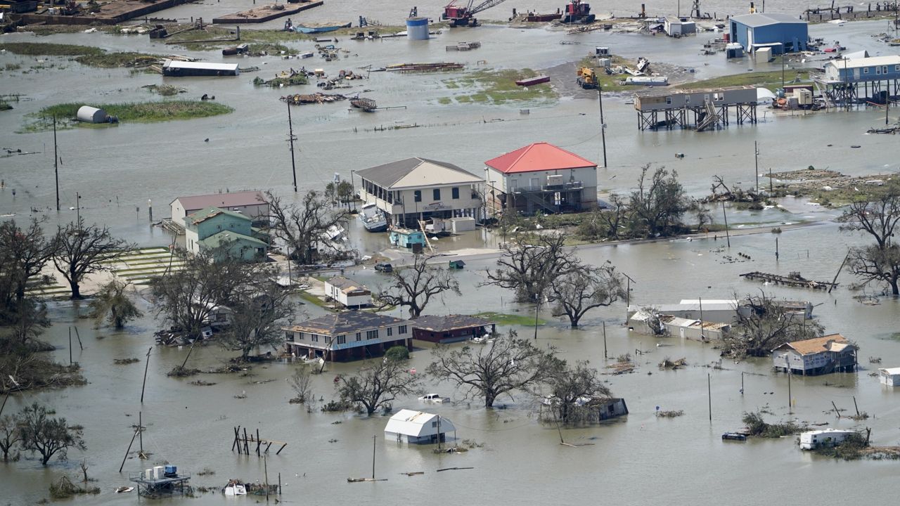 FILE - Buildings and homes are flooded in the aftermath of Hurricane Laura Thursday, Aug. 27, 2020, near Lake Charles, La. (AP Photo/David J. Phillip, File)