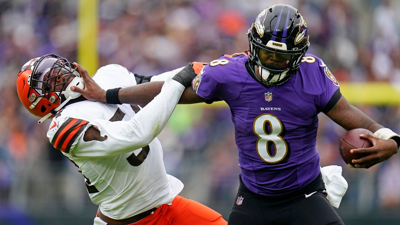 Ravens quarterback Lamar Jackson fend offs Cleveland Browns linebacker Deion Jones on Sunday in Baltimore. (AP Photo/Julio Cortez)