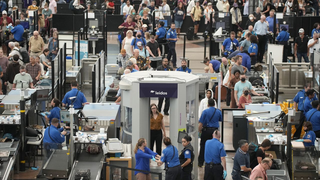 Travelers queue up at the south security checkpoint in Denver International Airport as the Labor Day holiday approaches Tuesday, Aug. 30, 2022, in Denver. (AP Photo/David Zalubowski)