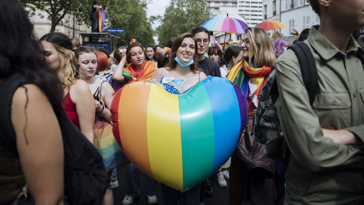 FILE - A participant holds a rainbow heart during the annual Gay Pride march in Paris, June 26, 2021. (AP Photo/Lewis Joly, File)