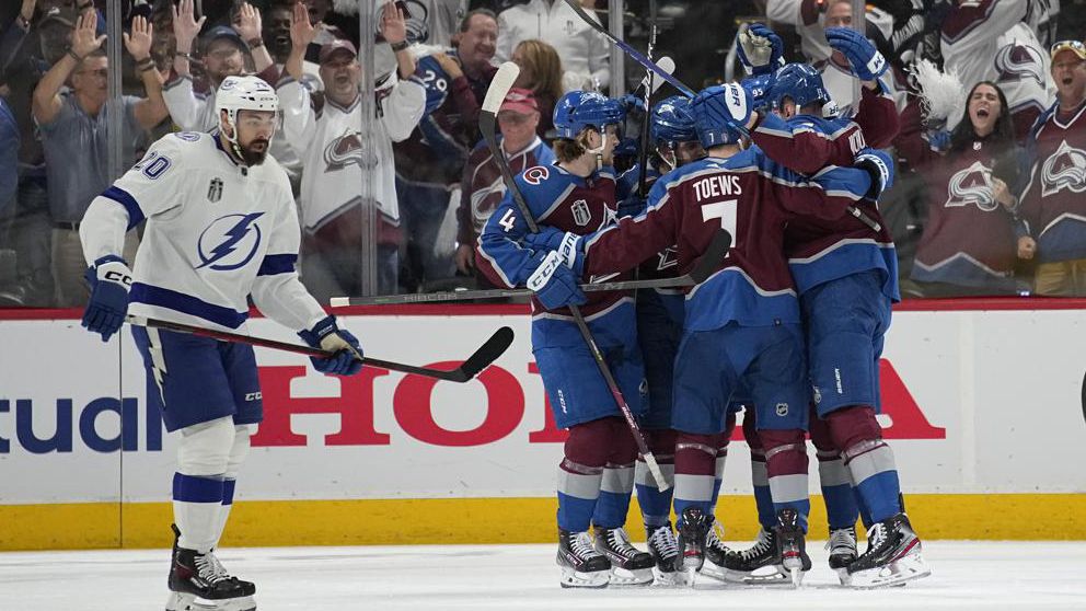 Colorado Avalanche players celebrate a goal by Valeri Nichushkin as Tampa Bay Lightning left wing Nicholas Paul, left, skates past during the first period in Game 2 of the NHL hockey Stanley Cup Final on Saturday, June 18, 2022, in Denver. (AP Photo/John Locher)