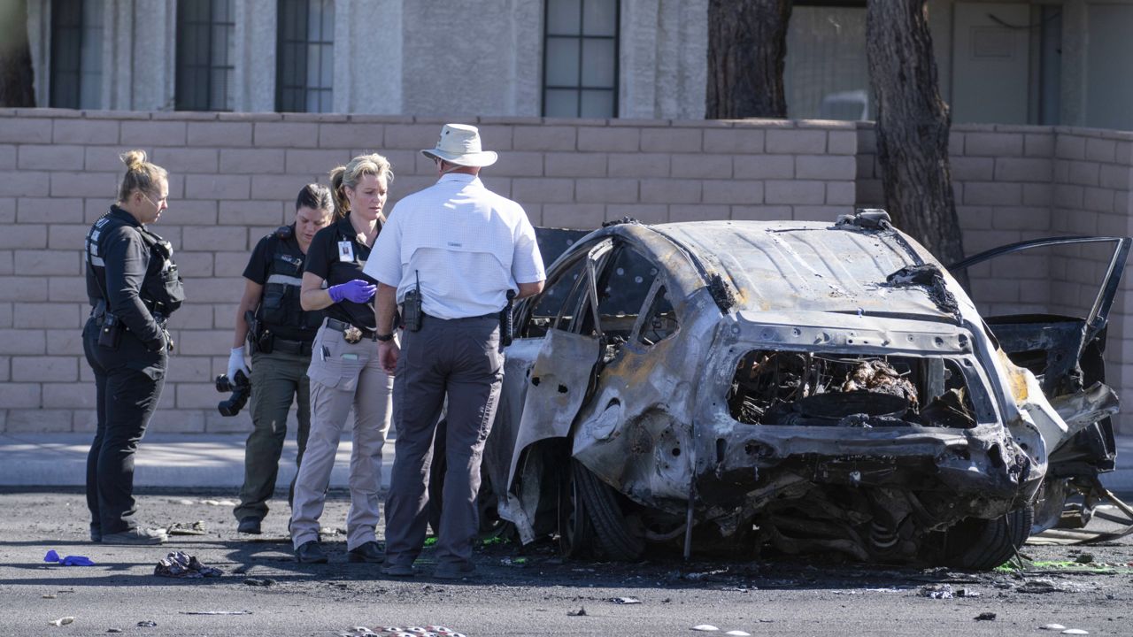 Las Vegas Metro Police investigators work at the scene of a fatal crash Tuesday, Nov. 2, 2021, in Las Vegas. (AP Photo/Eric Jamison)