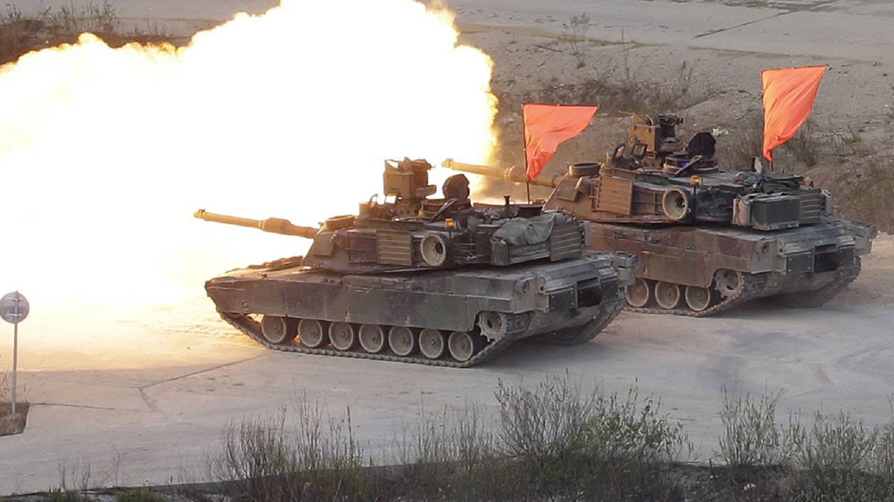 In this 2017, file photo, U.S. Army's M1 A2 tanks fire during South Korea-U.S. joint military live-fire drills at Seungjin Fire Training Field in Pocheon, South Korea, near the border with North Korea. The South Korean and U.S. militaries have postponed on Thursday, Feb. 27, 2020, their annual joint drills out of concerns over a virus outbreak. (AP Photo/Ahn Young-joon, File)