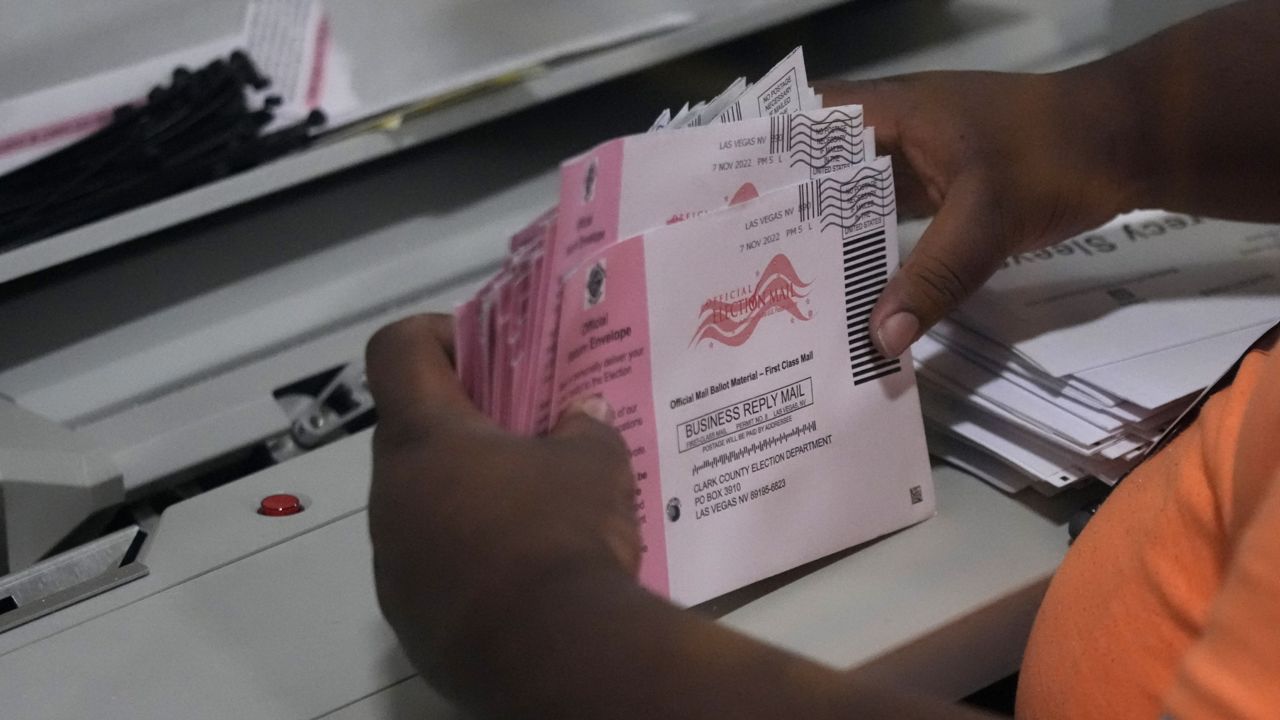 An election worker prepares mail-in ballots at the Clark County Election Department on Tuesday, Nov. 8, 2022, in Las Vegas. (AP Photo/John Locher)