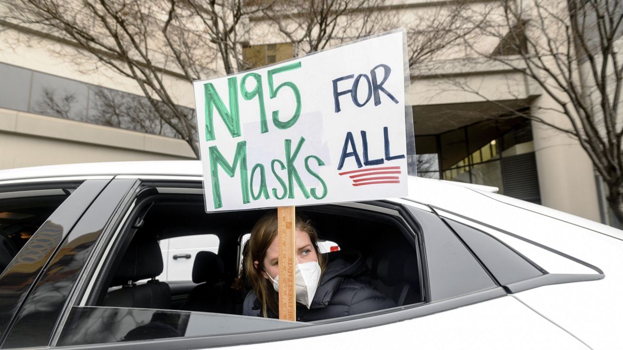 FILE - Elementary school teacher Carrie Landheer protests for stronger COVID-19 safety protocols outside Oakland Unified School District headquarters on Jan. 7, 2022, in Oakland, Calif. (AP Photo/Noah Berger, File)