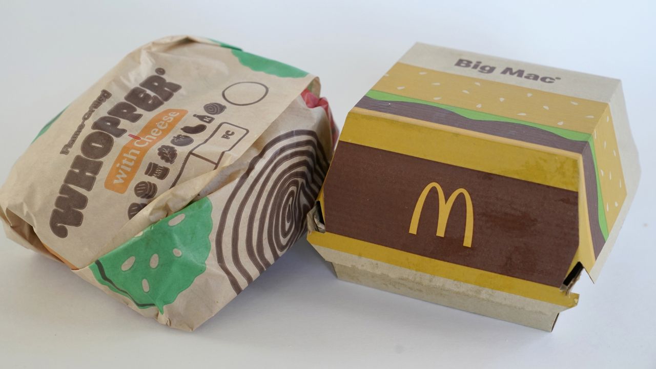 FILE: A Burger King Whopper in a wrapper, left, rests next to a McDonald's Big Mac in a container, in Walpole, Mass., Wednesday, April 20, 2022. (AP Photo/Steven Senne)