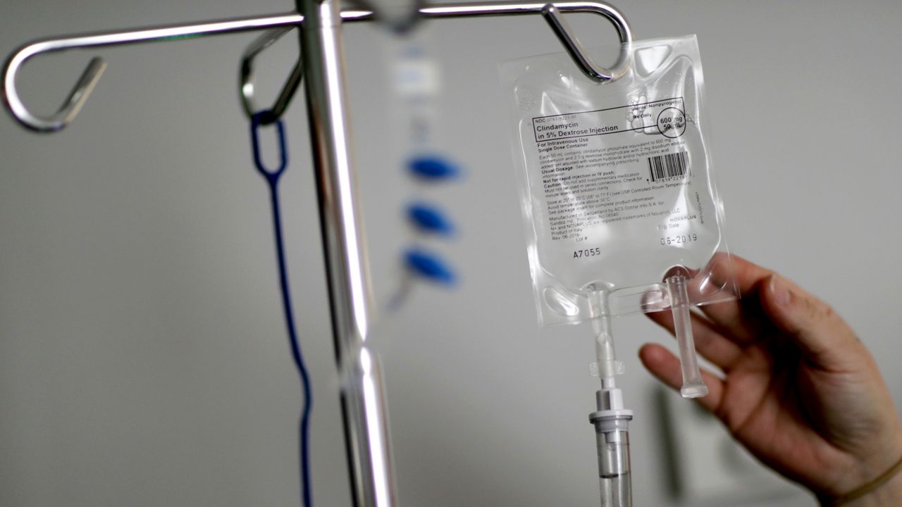 In this Feb. 9, 2018, file photo, a nurse hooks up an IV to a flu patient at Upson Regional Medical Center in Thomaston, Ga. (AP Photo/David Goldman, File)