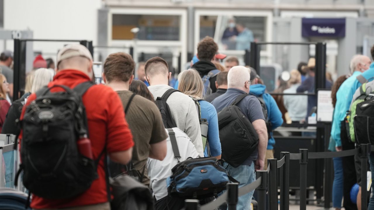 Travelers queue up at the north security checkpoint in the main terminal of Denver International Airport, Thursday, May 26, 2022, in Denver. (AP Photo/David Zalubowski, File)