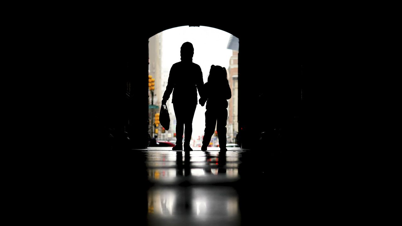 Pedestrians pass beneath City Hall in Philadelphia, Feb. 3, 2022. (AP Photo/Matt Rourke, File)