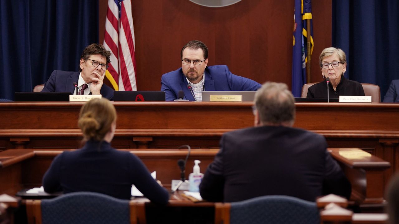 Members of the Michigan Board of State Canvassers, from left, Richard Houskamp, Anthony Daunt and Mary Ellen Gurewitz listen to attorneys Olivia Flower and Steve Liedel during a hearing, Wednesday, Aug. 31, 2022, in Lansing, Mich. (AP Photo/Carlos Osorio)