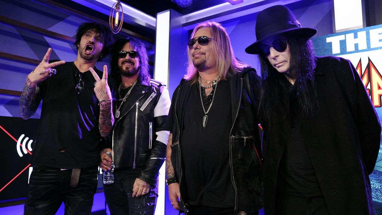 Tommy Lee, from left, Nikki Sixx, Vince Neil and Mick Mars of Motley Crue pose together during a news conference to announce The Stadium Tour 2020 featuring Motley Crue, Poison and Def Leppard, at the SiriusXM offices, Wednesday, Dec. 4, 2019, in Los Angeles. (AP Photo/Chris Pizzello)