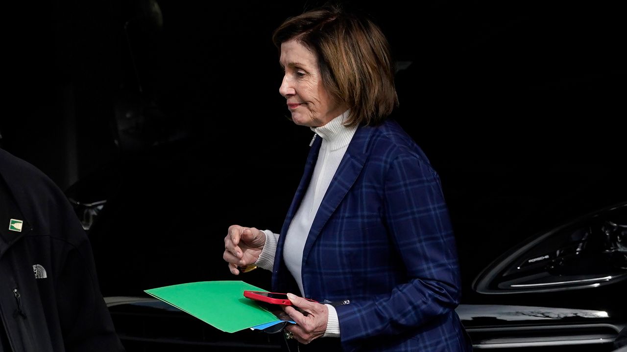 House Speaker Nancy Pelosi is escorted to a vehicle outside of her home in San Francisco, Friday, Nov. 4, 2022. (AP Photo/Jeff Chiu)