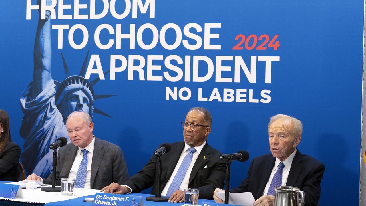 Labels leadership and guests from left, Dan Webb, National Co-Chair Dr. Benjamin F. Chavis, and founding Chairman and former Senator Joe Lieberman, speak about the 2024 election at National Press Club, in Washington, Jan. 18, 2024. (AP Photo/Jose Luis Magana)