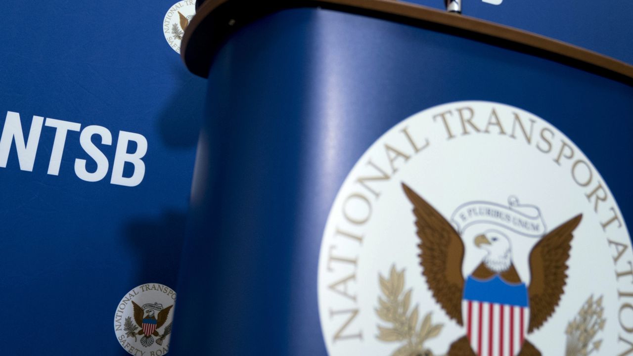 The National Transportation Safety Board logo and signage are seen at a news conference at NTSB headquarters in Washington, Dec. 18, 2017. (AP Photo/Andrew Harnik, File)