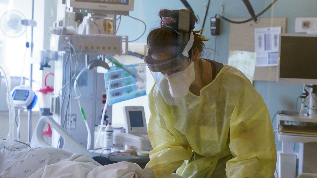 FILE: A nurse cares for a critically ill patient in the ICU at Oregon Health and Science University in Portland, Ore., Aug. 19, 2021.  (Kristyna Wentz-Graff/Oregon Public Broadcasting via AP, Pool)