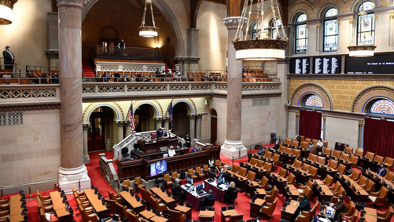 Members of the New York state Assembly work in the Assembly Chamber at the state Capitol, Monday, Jan. 11, 2021, in Albany, N.Y. (AP Photo/Hans Pennink)