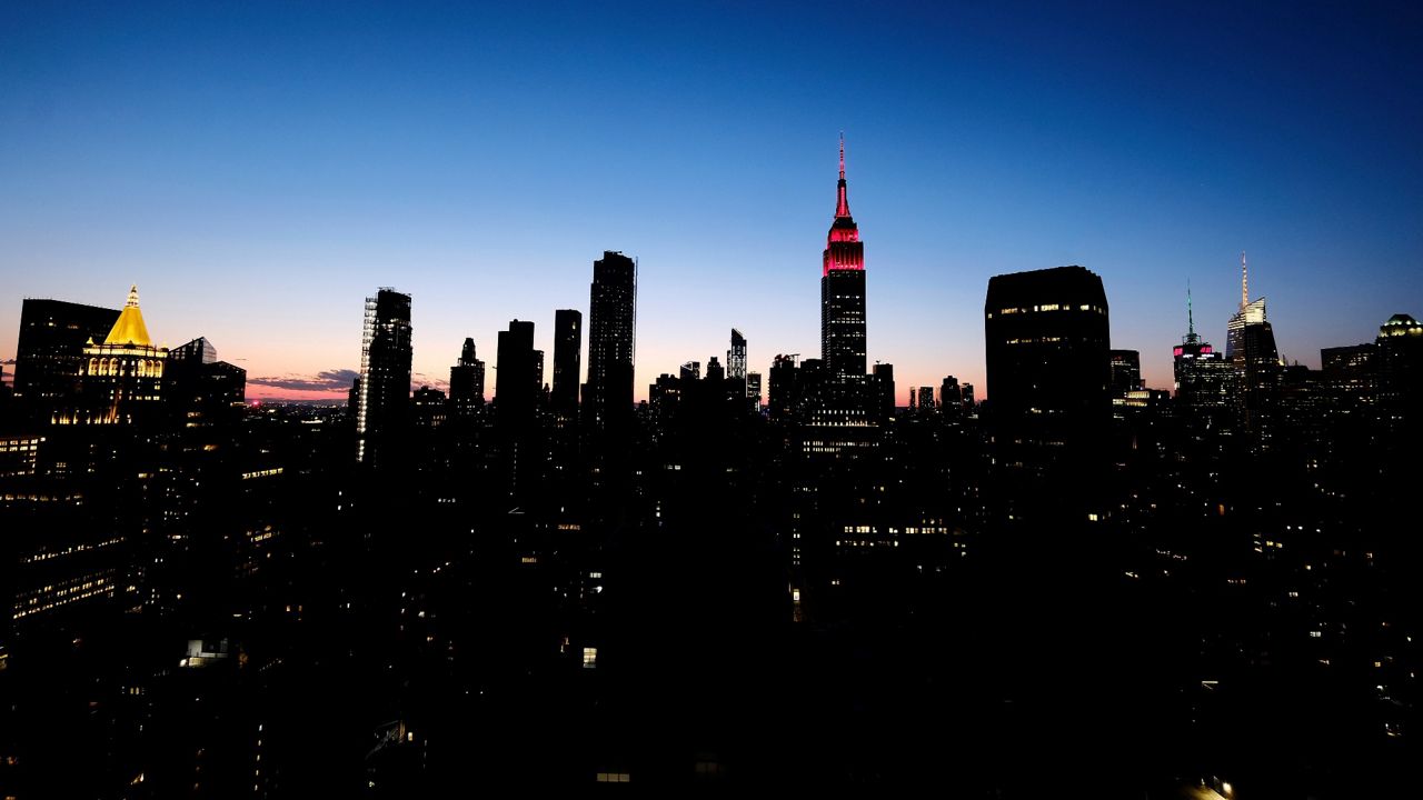 The Empire State Building lit red to recognize first responders during Covid-19 lockdown, Wednesday, April 8, 2020, in New York.