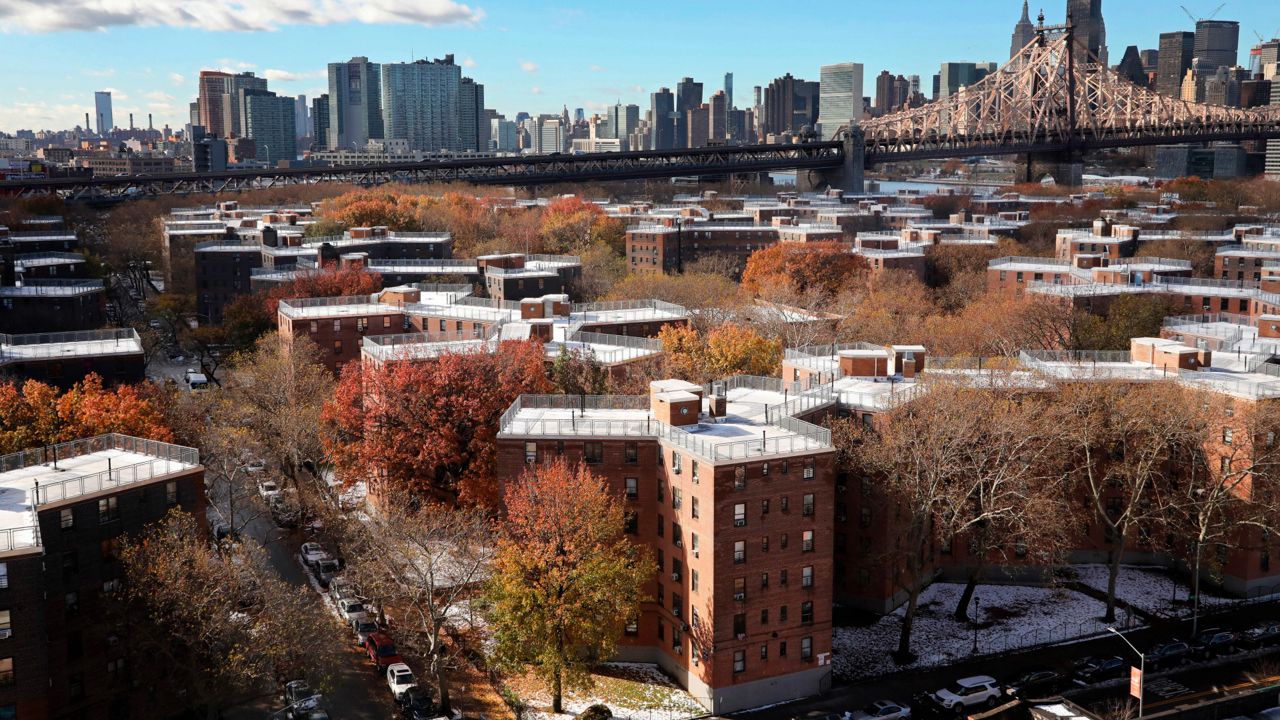 The city plans to remove sidewalk sheds from dozens of NYCHA buildings, including some sheds that have been up for as long as five years. (AP Photo/Mark Lennihan, File)