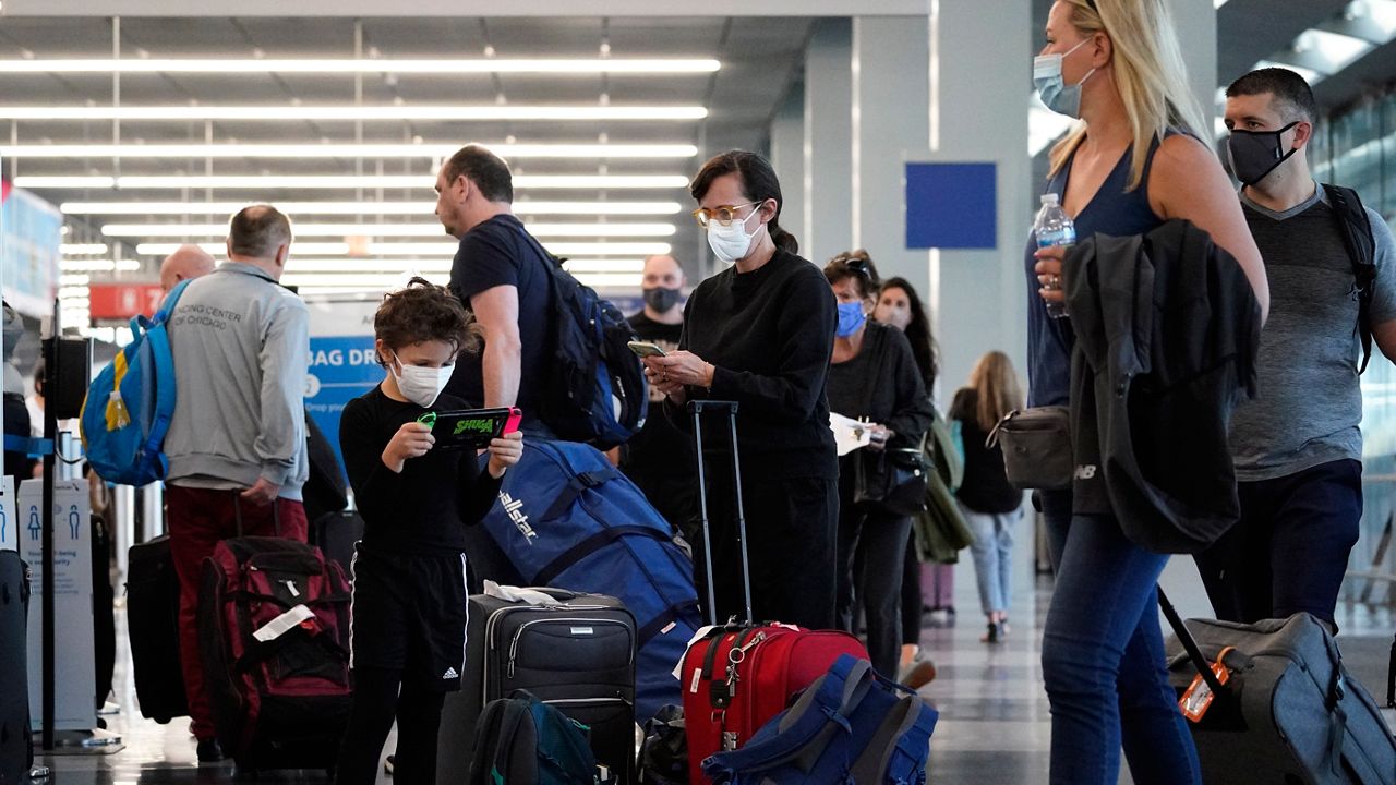 Travelers are lining up at O'Hare airport in Chicago, Friday, July 2, 2021. The U.S. set another pandemic-era record for travel on Sunday, Aug. 1, with more than 2.2 million people going through airport checkpoints. That's the biggest number in 17 months, although travel is still not quite back to pre-pandemic levels. (AP Photo/Nam Y. Huh)