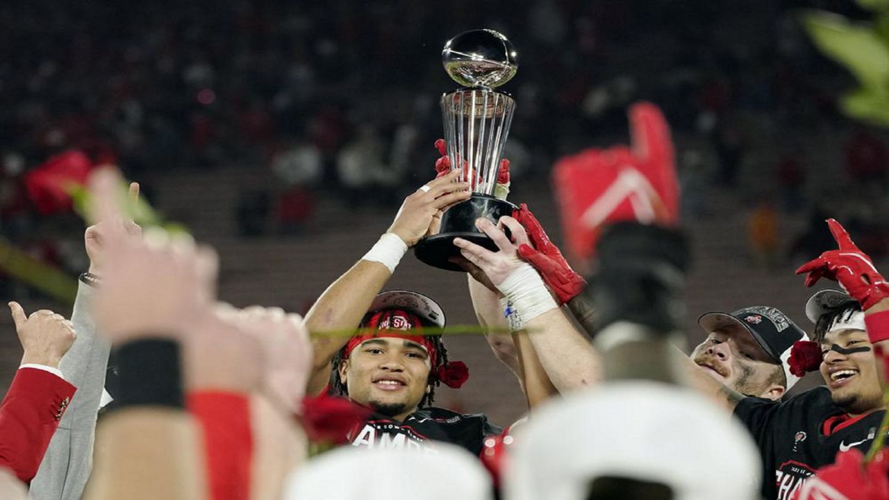 Ohio State quarterback C.J. Stroud holds the game winner's trophy after defeating Utah during the Rose Bowl NCAA college football game Saturday, Jan. 1, 2022, in Pasadena, Calif. (AP Photo/Mark J. Terrill)