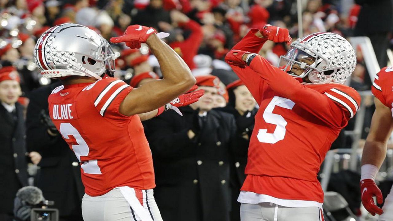 Ohio State receiver Garrett Wilson, right, celebrates his touchdown against Purdue with teammate Chris Olave during the first half of an NCAA college football game, Saturday, Nov. 13, 2021, in Columbus, Ohio. (AP Photo/Jay LaPrete)