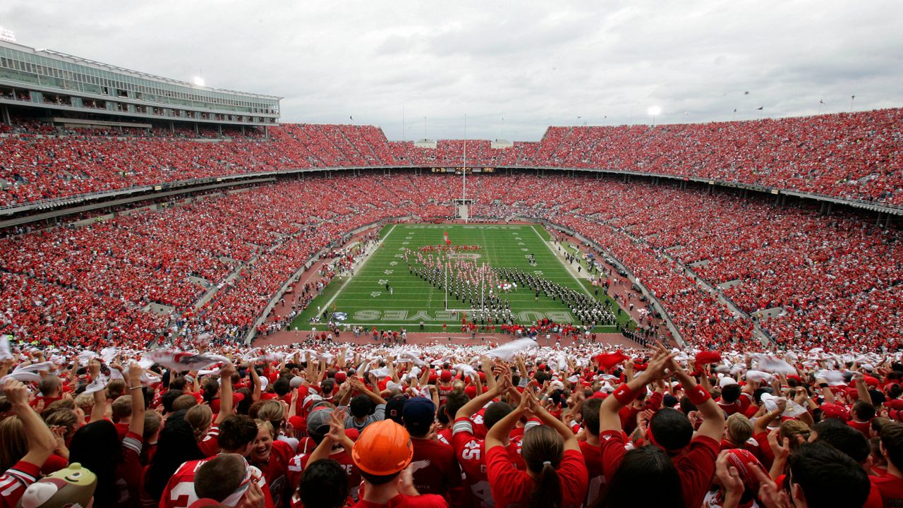 ** FILE ** In this Sept. 23, 2006 file photo, Ohio State football fans cheer at Ohio Stadium as the football team enters the field at the Ohio Stadium before a football game against Penn State in Columbus, Ohio. Just days away from the kickoff of the new football season, Ohio State University officials are saying that the last one saw a sharp increase in alcohol-related citations on game days. At the seven home games in 2006, 410 tailgaters were cited for open-container violations, more than double the 204 fans cited by state liquor agents the year before.(AP Photo/Kiichiro Sato, File)