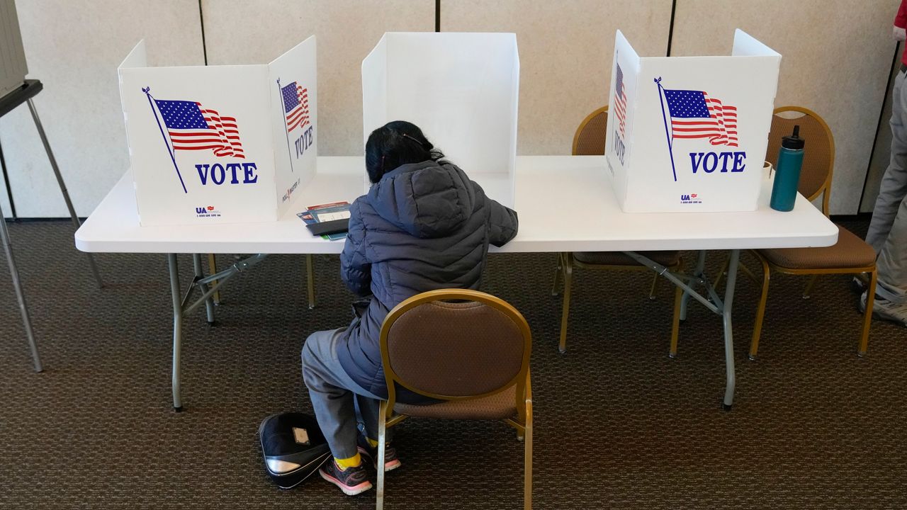 An Ohio voter fills out a manual ballot as voting continued at the Meadowbook Golf Club in Clayton, Ohio Tuesday, Nov. 8, 2022. (AP Photo/Michael Conroy)