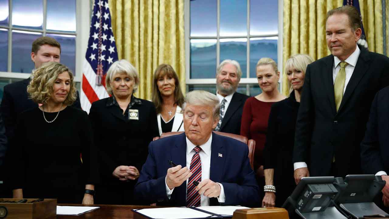 President Donald Trump prepares to sign the Preventing Animal Cruelty and Torture Act during a bill signing ceremony in the Oval Office of the White House, Monday, Nov. 25, 2019, in Washington. (AP Photo/Patrick Semansky)
