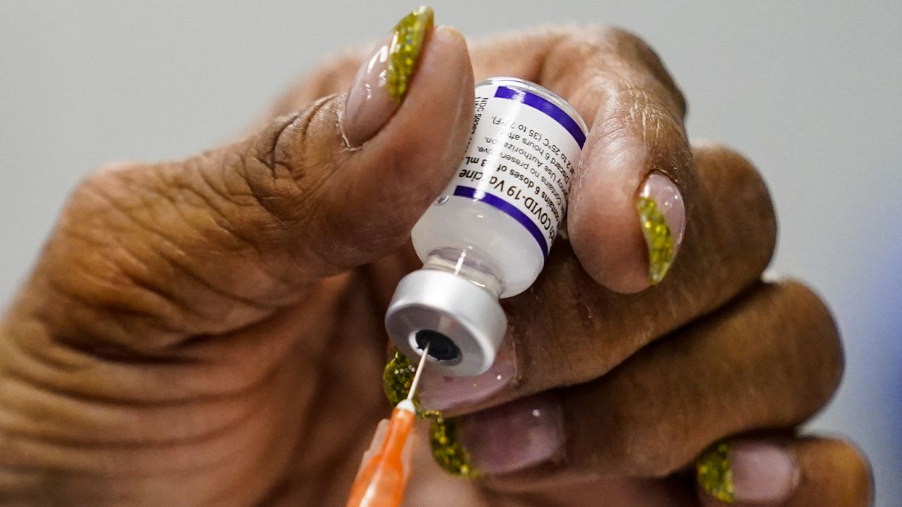 FILE: A syringe is prepared with the Pfizer COVID-19 vaccine at a vaccination clinic at the Keystone First Wellness Center in Chester, Pa., Wednesday, Dec. 15, 2021. (AP Photo/Matt Rourke)