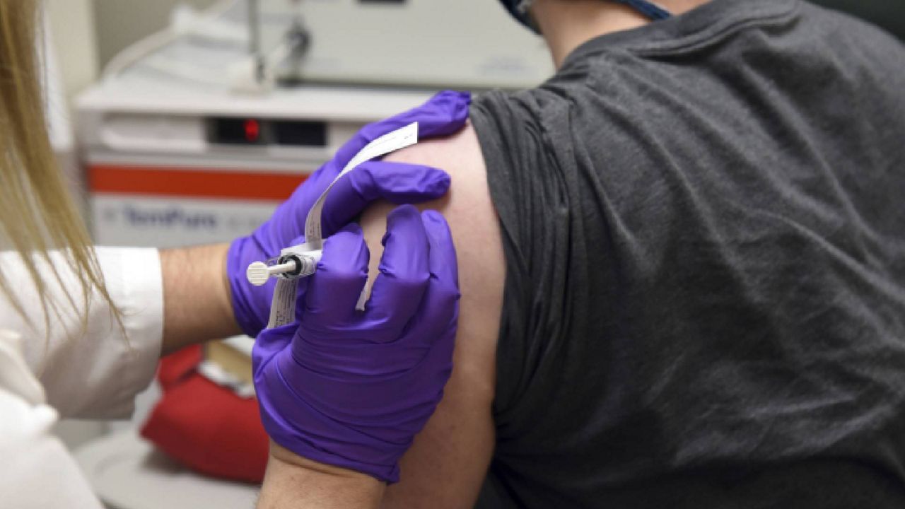 A patient is being injected with a COVID-19 vaccine. 