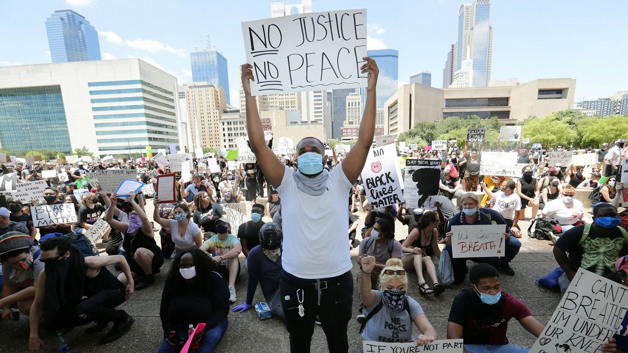 Protesters demonstrate police brutality in front of Dallas City Hall in downtown Dallas, Saturday, May 30, 2020. Protests across the country have escalated over the death of George Floyd who died after being restrained by Minneapolis police officers on Memorial Day. (AP Photo/LM Otero)