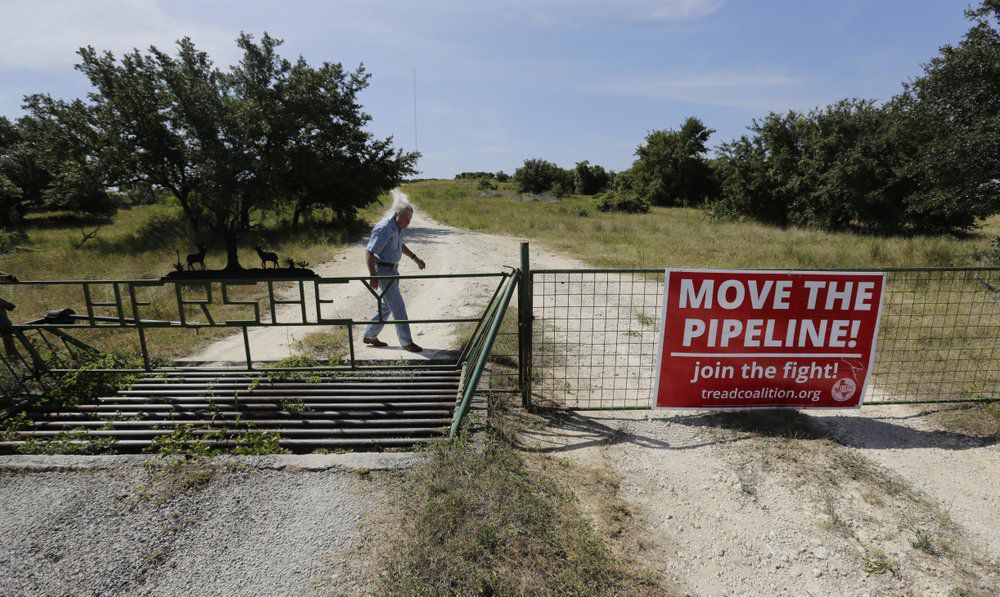 Andy Sansom walks on his property where a proposed new natural gas pipeline would pass through his ranch in the Texas Hill Country near Stonewall, Texas Friday, Aug. 2, 2019. A proposed pipeline is a 430-mile, $2 billion natural gas expressway that pipeline giant Kinder Morgan has mapped from the booming West Texas oil patch to Houston. (AP Photo/Eric Gay)