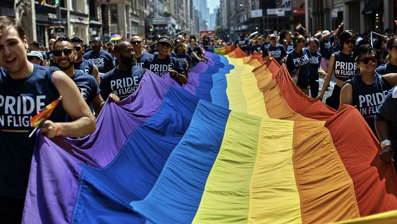 Reveler carry a LTBGQ flag along Fifth Avenue during the New York City Pride Parade on Sunday, June 24, 2018, in New York. The 2020 New York Pride Parade has been canceled because of the coronavirus pandemic. (AP Photo/Andres Kudacki)