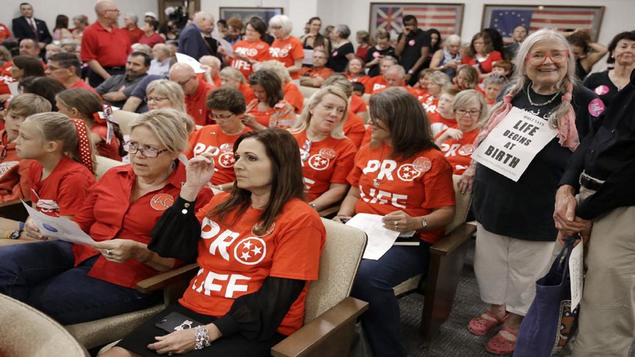 FILE - In this Aug. 12, 2019, file photo, people wait for a Senate hearing to begin to discuss a fetal heartbeat abortion ban, or possibly something more restrictive in Nashville, Tenn. (AP Photo/Mark Humphrey, File)