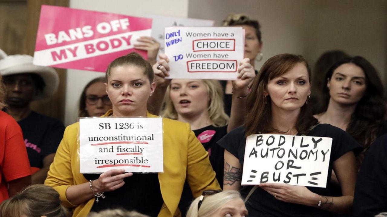 FILE - In this Aug. 12, 2019, file photo, people wait for a Senate hearing to begin to discuss a fetal heartbeat abortion ban, or possibly something more restrictive in Nashville, Tenn.  (AP Photo/Mark Humphrey, File)
