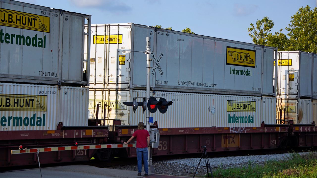 A CSX freight train runs through a crossing in Homestead, Pa., Wednesday, Sept. 14, 2022. (AP Photo/Gene J. Puskar)