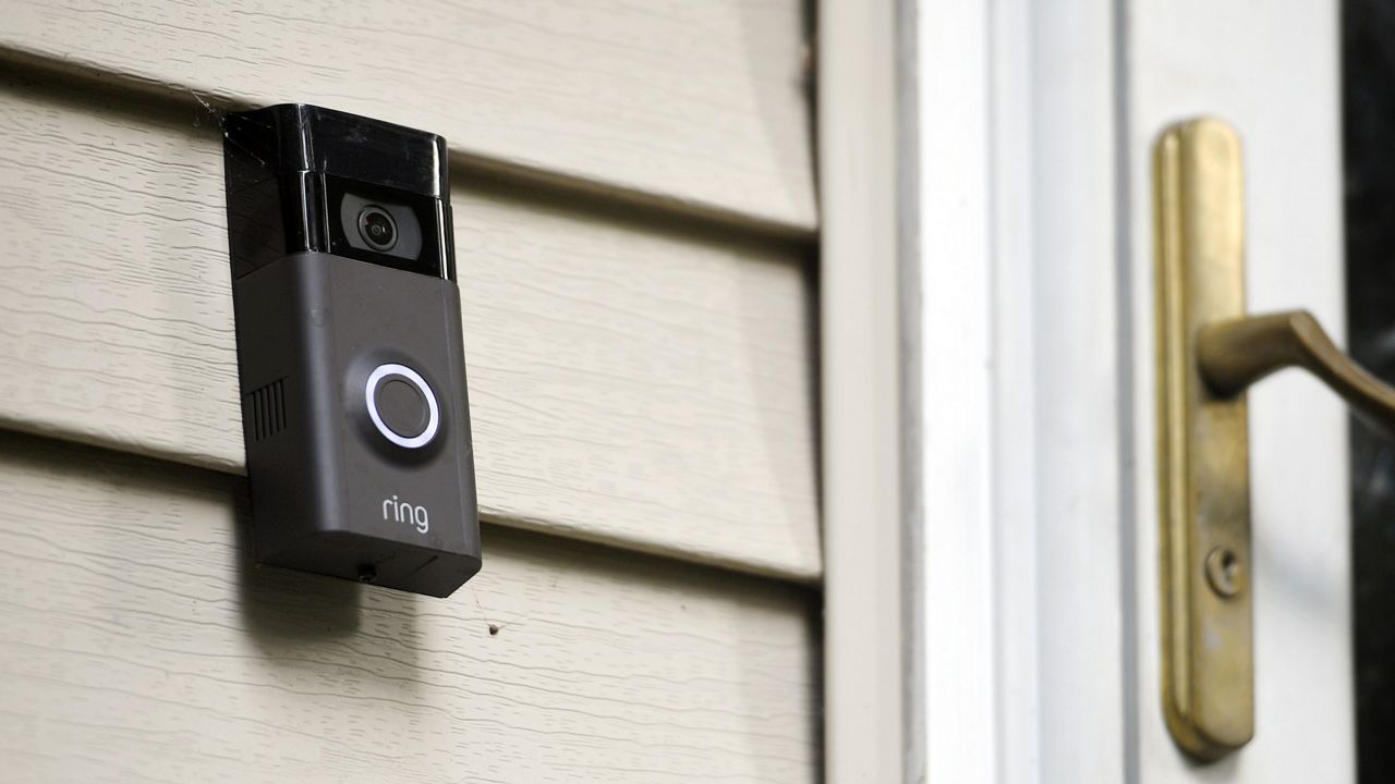 FILE - A Ring doorbell camera is displayed outside a home in Wolcott, Conn., on July 16, 2019. (AP Photo/Jessica Hill, File)