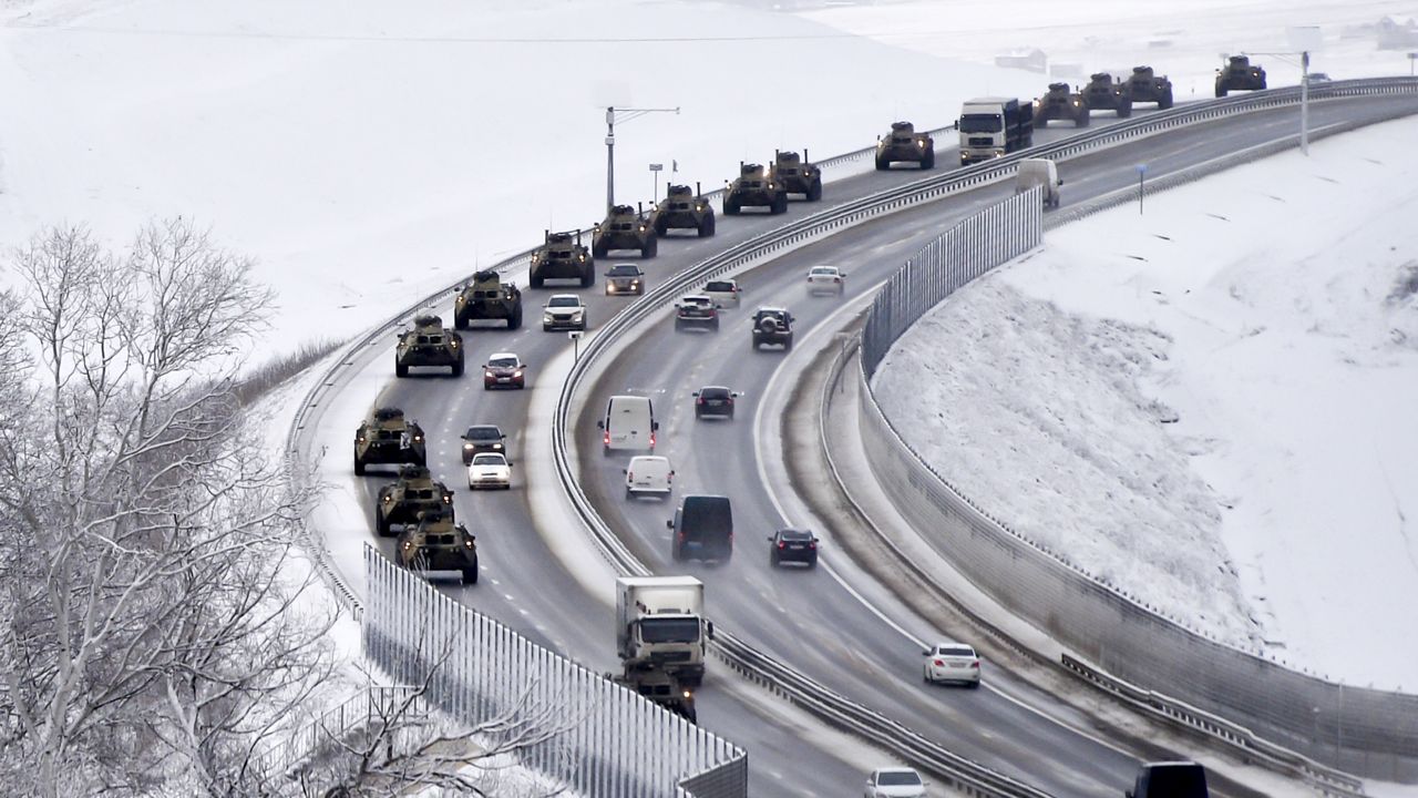A convoy of Russian armored vehicles moves along a highway in Crimea, Tuesday, Jan. 18, 2022. (AP Photo)