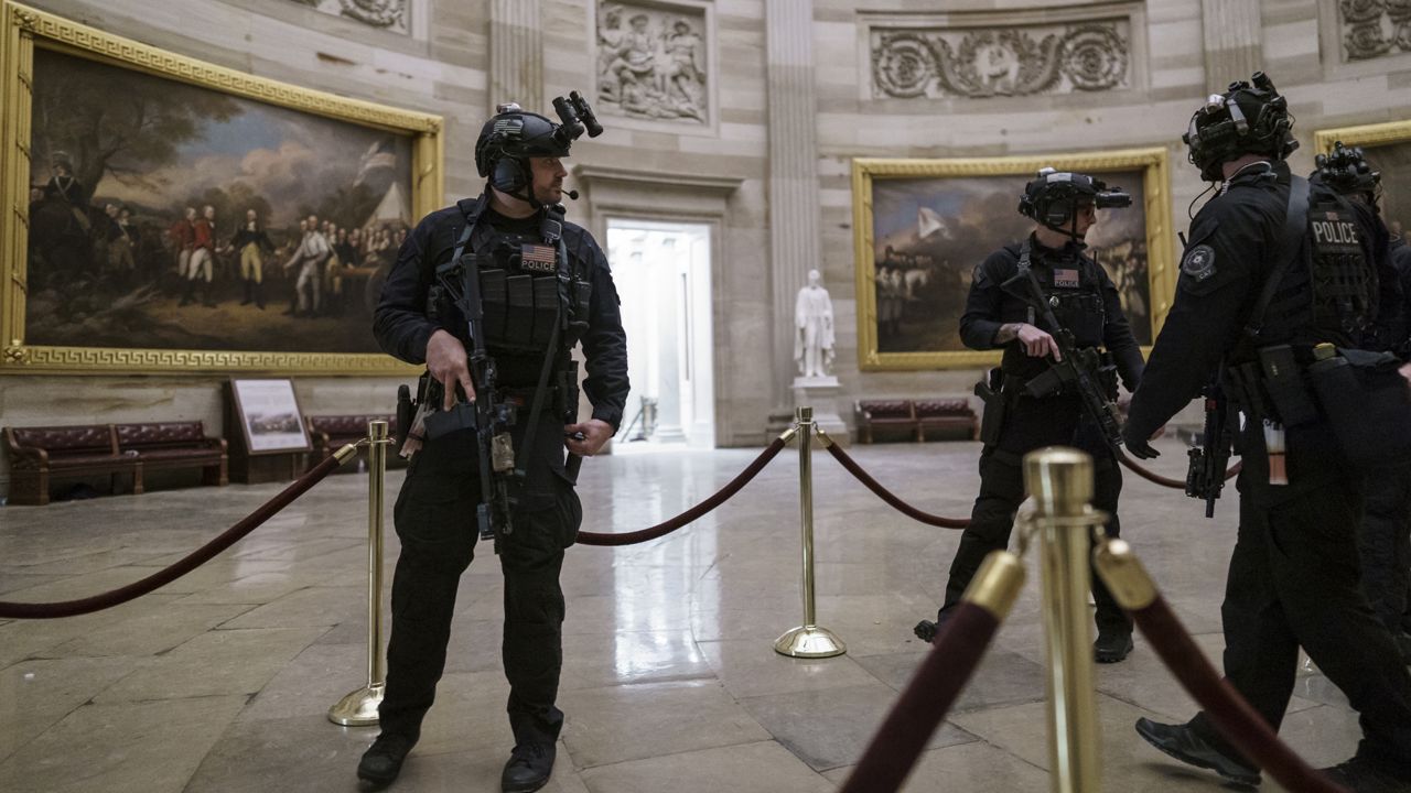 Members of the U.S. Secret Service Counter Assault Team walk through the Rotunda at the Capitol in Washington, Wednesday, Jan. 6, 2021. (AP Photo/J. Scott Applewhite)